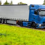 modern-blue-truck-wet-highway